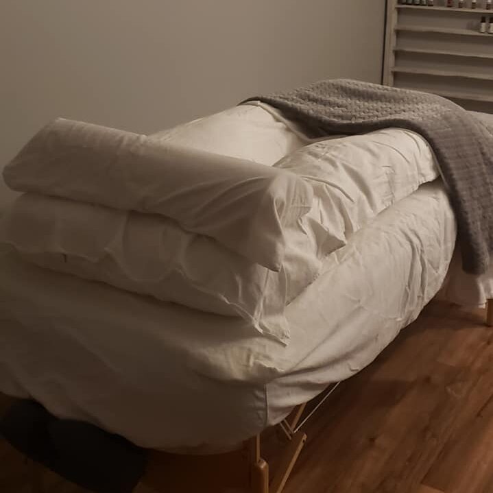 Massage table with pregnancy pillow.