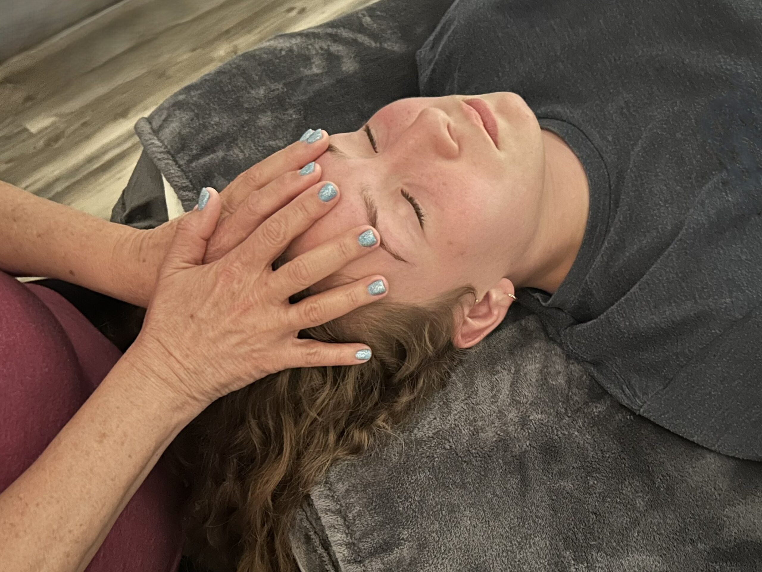 hands on massaging forehead and scalp