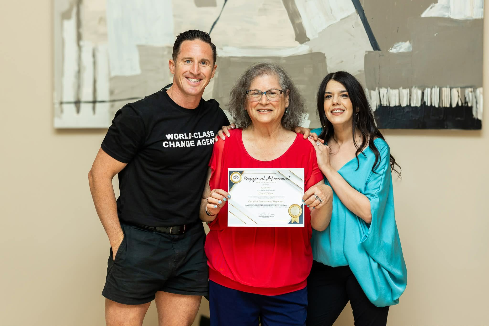 Gretel Seham poses with Leah Agami and Jack Cross. She is holding her Certified Professional Hypnotist certificate.
